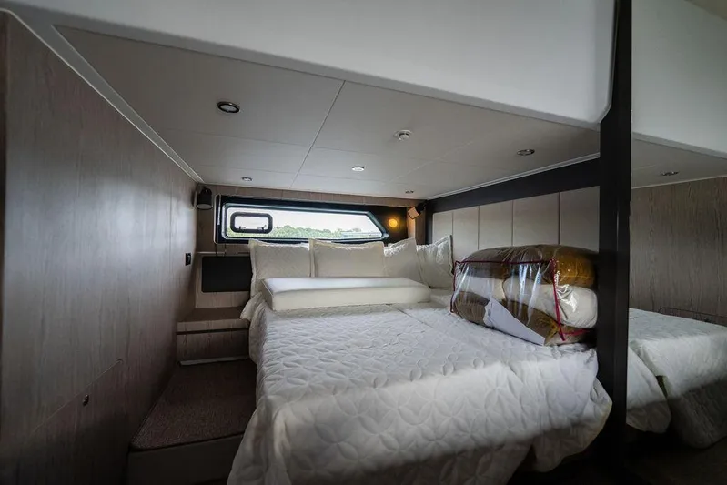  Yacht Photos Pics Luxurious bedroom interior of 2025 Azimut Atlantis 45 yacht with modern design and cozy bedding.