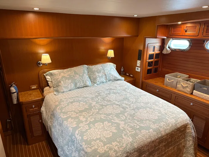 Marco Polo Yacht Photos Pics Luxurious 2004 Selene Pilothouse bedroom with elegant bedding and wooden interior.