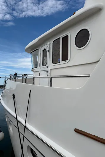 Marco Polo Yacht Photos Pics 2004 Selene Pilothouse yacht with white exterior, docked under a blue sky.