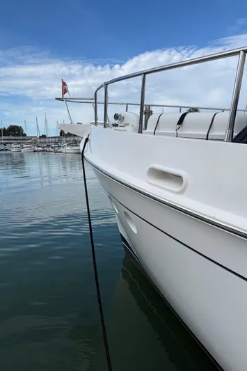 Marco Polo Yacht Photos Pics 2004 Selene Pilothouse yacht docked in a marina, calm water, clear sky.