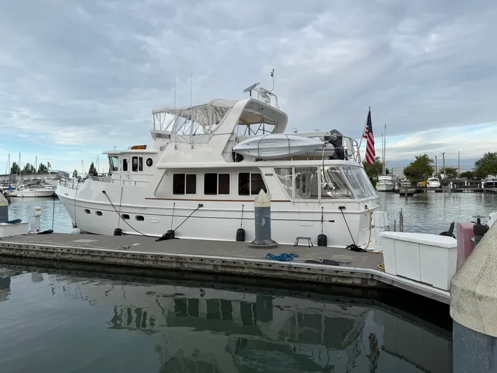 Marco Polo Yacht Photos Pics 2004 Selene Pilothouse yacht docked at marina under cloudy sky.