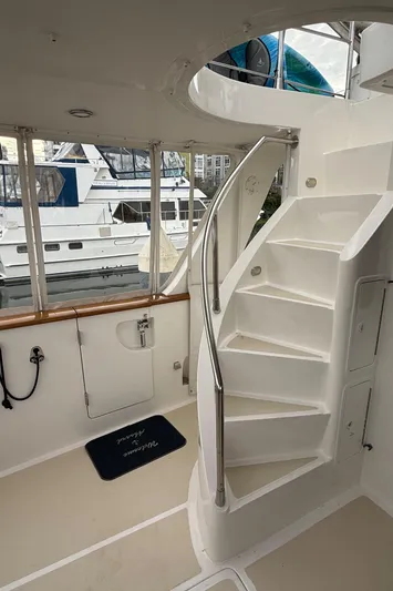 Marco Polo Yacht Photos Pics Interior of 2004 Selene Pilothouse yacht with spiral staircase and marina view.