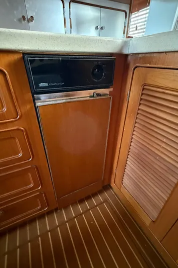 Marco Polo Yacht Photos Pics 2004 Selene Pilothouse interior with wooden cabinetry and built-in trash compactor.
