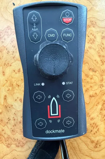 Marco Polo Yacht Photos Pics Remote control for Selene Pilothouse 2004, featuring joystick and function buttons on wooden surface.