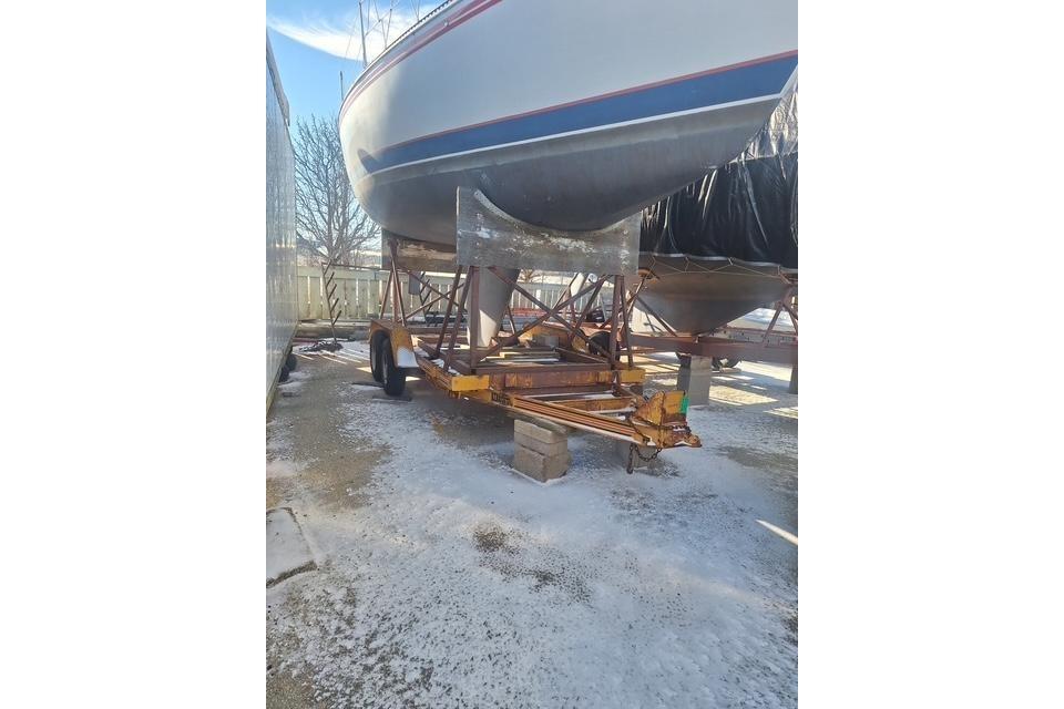 1983 Express 30 sailboat on trailer, winter storage, outdoor setting.