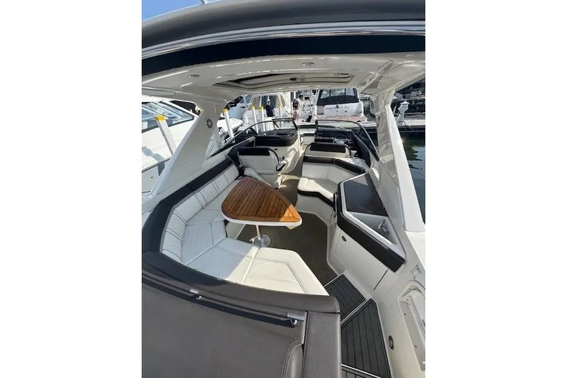  Yacht Photos Pics 2017 Sea Ray SLX 310 Outboard interior with seating and wooden table.