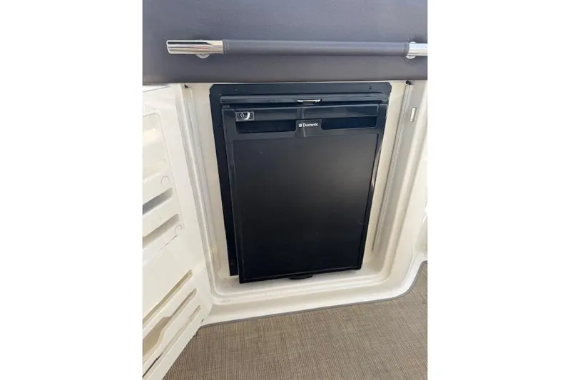  Yacht Photos Pics 2017 Sea Ray SLX 310 Outboard boat interior with a compact Dometic refrigerator.