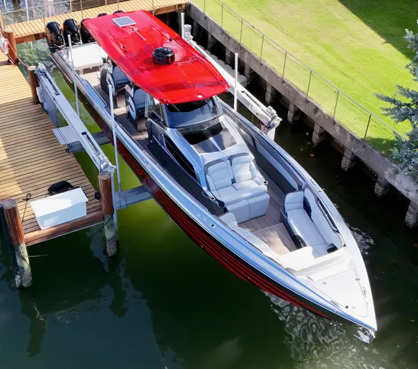  Yacht Photos Pics 2022 Nor-Tech 50 Sport boat docked, featuring sleek design and vibrant red roof.