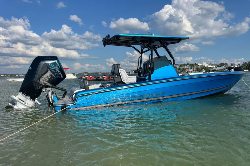  Yacht Photos Pics 2025 Concept 27' Open Deck boat in blue, anchored in calm waters under a cloudy sky.