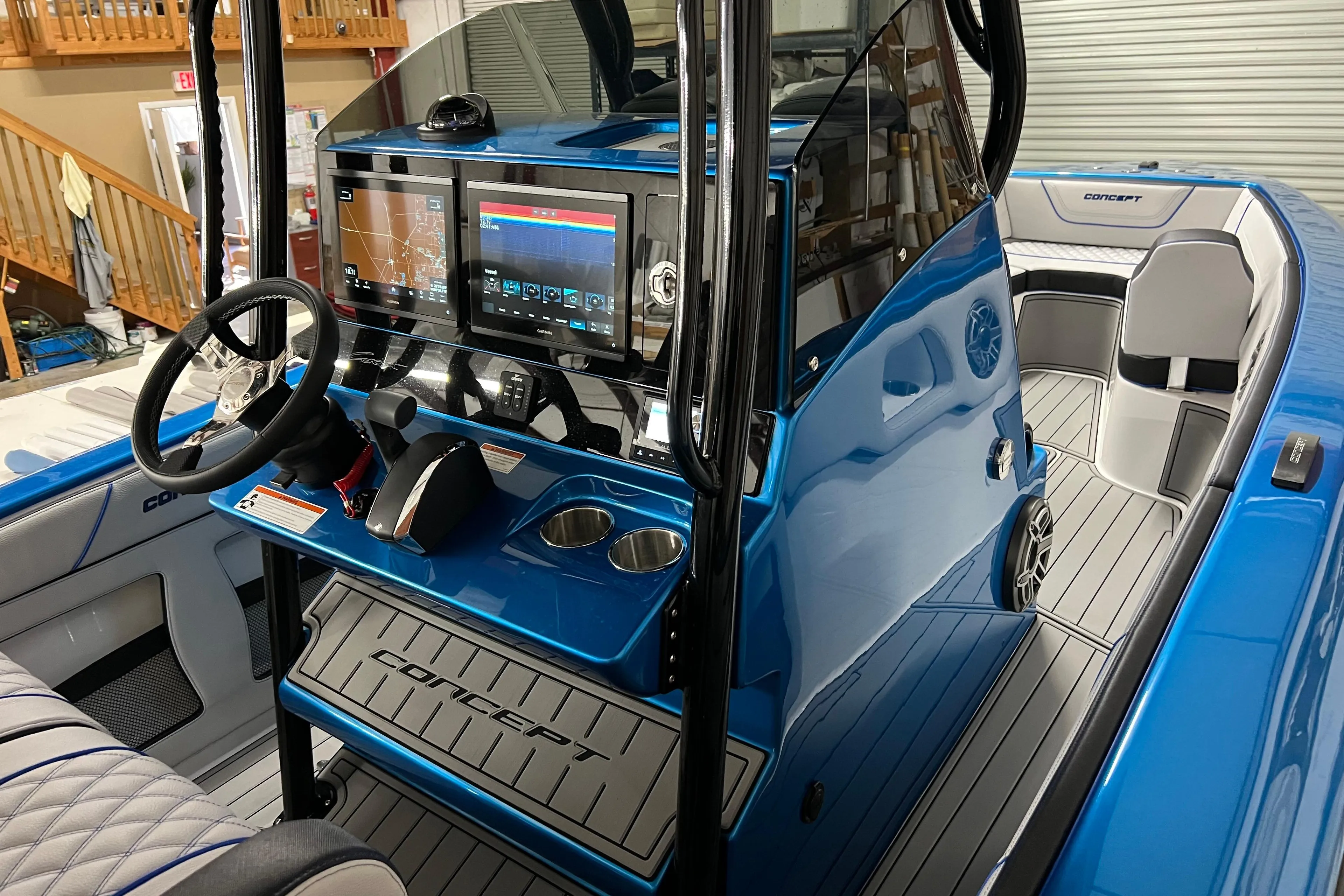 2025 Concept 27' Open Deck boat interior with modern dashboard and sleek blue design.