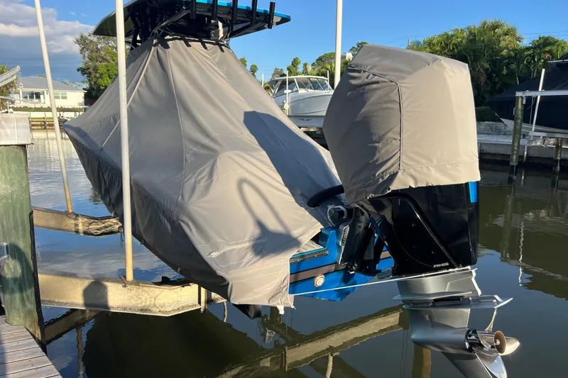  Yacht Photos Pics Covered 2025 Concept 27' Open Deck boat with outboard motor at dock.