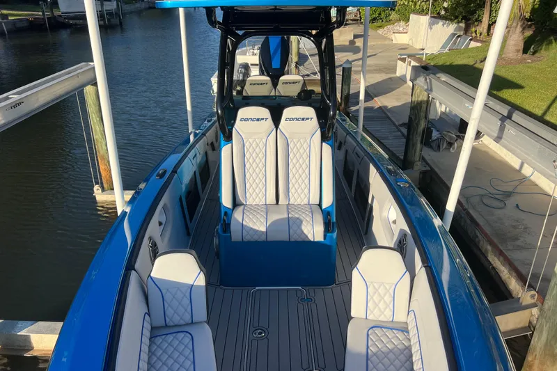  Yacht Photos Pics 2025 Concept 27' Open Deck boat with blue and white seating, docked by the water.