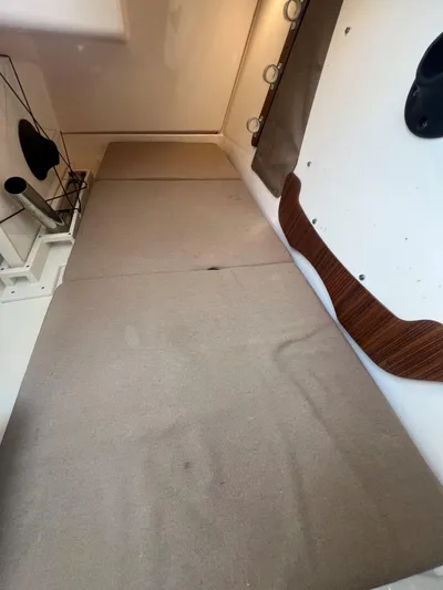 Pursuit 32dc Yacht Photos Pics Interior cabin of a 2015 Pursuit 325DC boat with beige cushions and wooden accents.