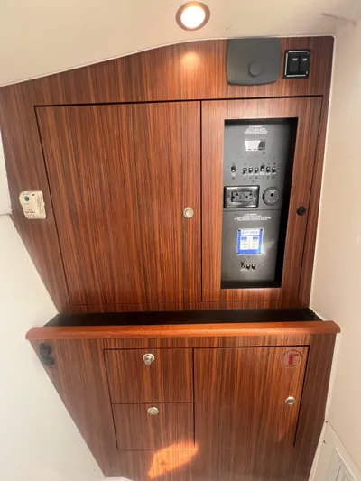 Pursuit 32dc Yacht Photos Pics 2015 Pursuit 325DC control panel with wood finish and electrical switches.