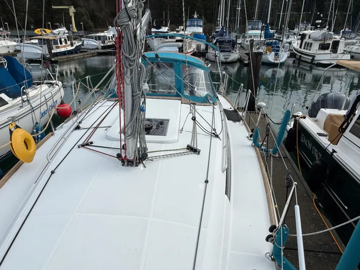 Seaglass Yacht Photos Pics 2019 Jeanneau Sun Odyssey 349 sailboat docked in a marina, surrounded by other boats.