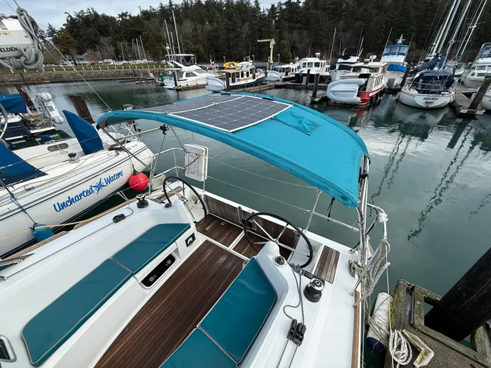 Seaglass Yacht Photos Pics Jeanneau Sun Odyssey 349 sailboat, 2019 model, docked with solar panel and blue canopy.