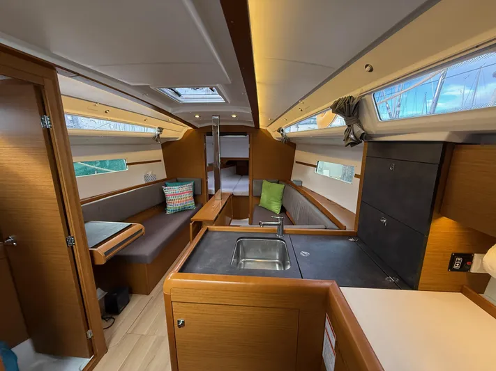 Seaglass Yacht Photos Pics 2019 Jeanneau Sun Odyssey 349 interior with modern kitchen and cozy seating area.