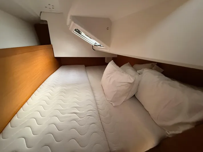 Seaglass Yacht Photos Pics Cozy cabin interior of 2019 Jeanneau Sun Odyssey 349 sailboat with comfortable bedding.
