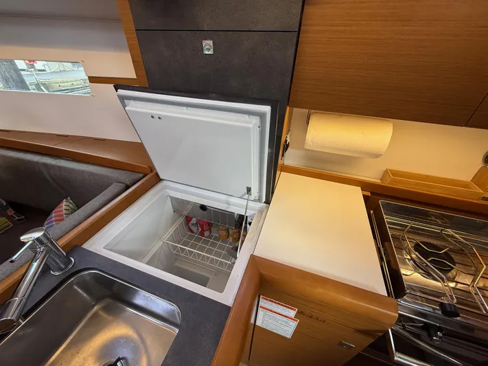 Seaglass Yacht Photos Pics Interior of 2019 Jeanneau Sun Odyssey 349 yacht kitchen with sink, fridge, and stove.
