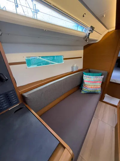 Seaglass Yacht Photos Pics Interior of 2019 Jeanneau Sun Odyssey 349 sailboat with cozy seating and colorful pillow.