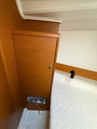 Seaglass Yacht Photos Pics Interior cabin of 2019 Jeanneau Sun Odyssey 349 with wooden cabinet and bed.