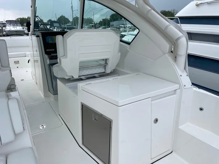  Yacht Photos Pics 2024 Pursuit DC 326 Dual Console interior with seating and storage, docked at marina.