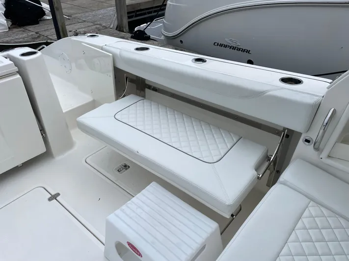  Yacht Photos Pics 2024 Pursuit DC 326 Dual Console boat with white cushioned seating and cup holders.