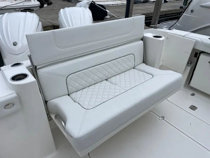  Yacht Photos Pics 2024 Pursuit DC 326 Dual Console boat with white cushioned seating and cup holders.
