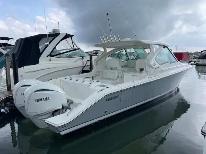  Yacht Photos Pics 2024 Pursuit DC 326 Dual Console boat with Yamaha engines docked in a marina.