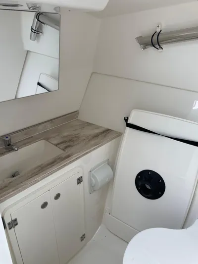  Yacht Photos Pics 2024 Pursuit DC 326 Dual Console boat interior with sink and storage.