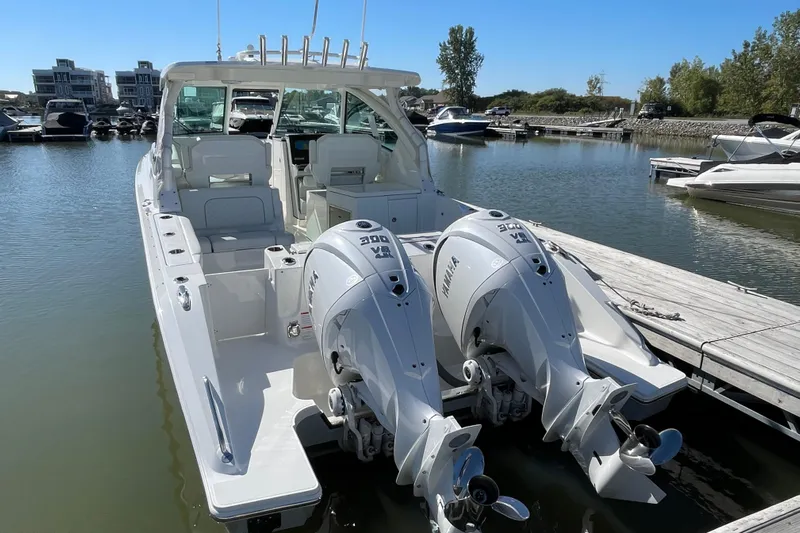  Yacht Photos Pics 2024 Pursuit DC 326 Dual Console boat docked with twin Yamaha engines.