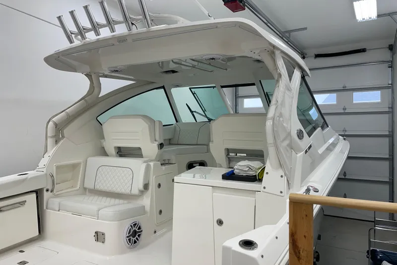  Yacht Photos Pics 2024 Pursuit DC 326 Dual Console boat interior in a garage setting.
