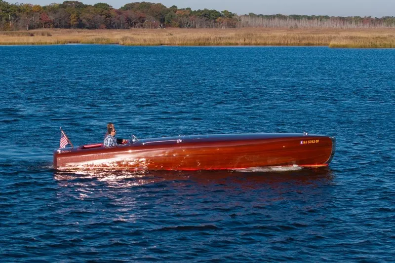  Yacht Photos Pics Custom 1998 30 Gentleman's Racer boat cruising on a serene lake.