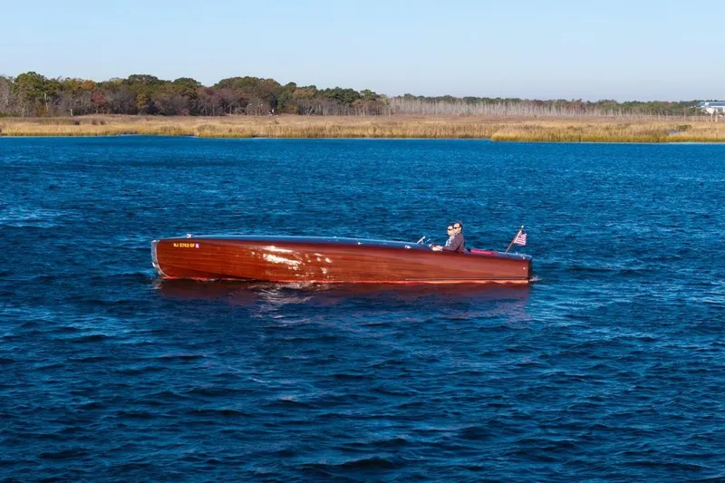 Yacht Photos Pics Custom 1998 30 Gentleman's Racer boat cruising on a serene lake with scenic background.
