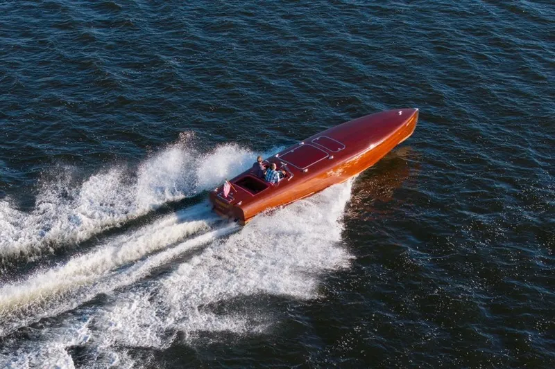  Yacht Photos Pics Custom 1998 30 Gentleman's Racer speeding on open water, creating a dynamic wake.