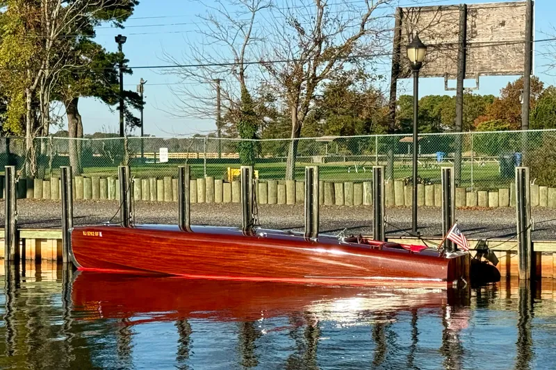  Yacht Photos Pics Custom 1998 30 Gentleman's Racer boat docked by a scenic waterfront.