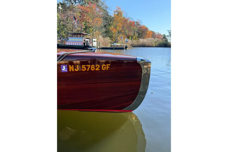  Yacht Photos Pics Custom 1998 30 Gentleman's Racer boat on calm water, autumn trees in background.