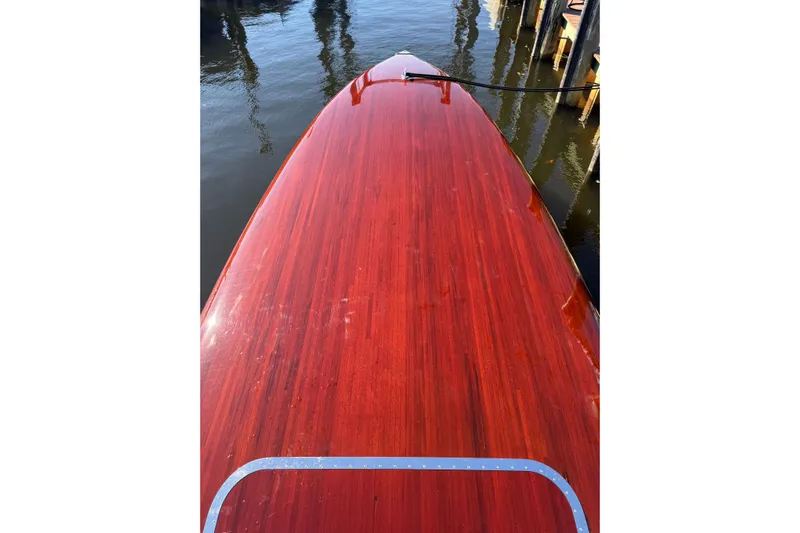  Yacht Photos Pics Polished wooden deck of a 1998 Custom 30 Gentleman's Racer boat at a dock.