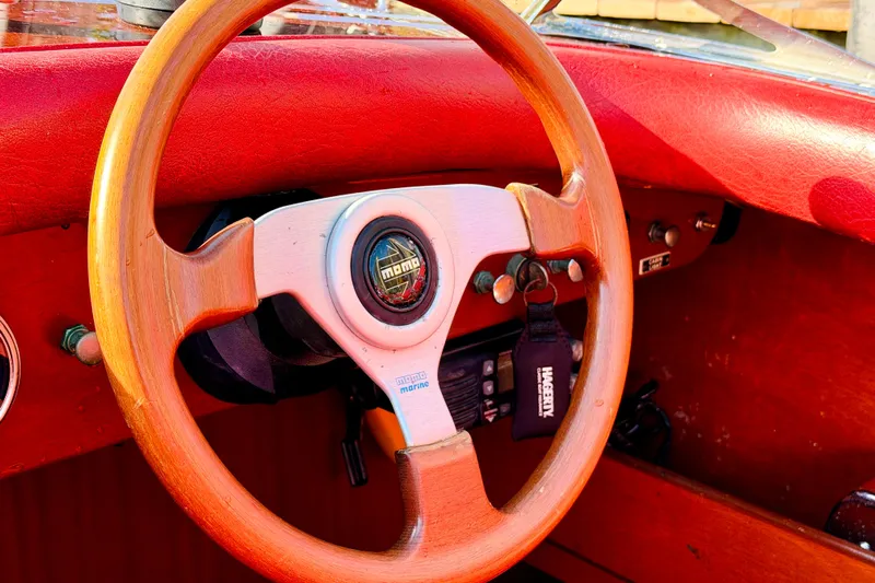 Yacht Photos Pics Wooden steering wheel of a 1998 Custom 30 Gentleman's Racer with red leather interior.
