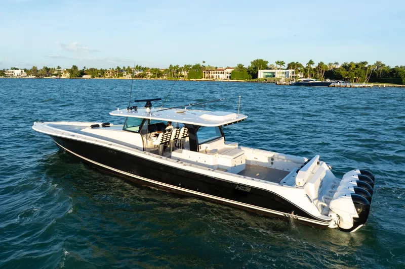  Yacht Photos Pics 2021 HCB 65 Estrella luxury boat cruising on a sunny day near a coastal area.