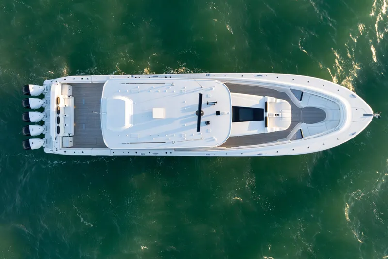  Yacht Photos Pics Aerial view of 2021 HCB 65 Estrella luxury yacht on green ocean water.