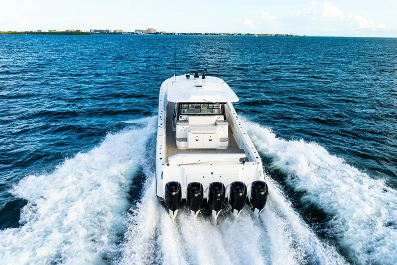  Yacht Photos Pics 2021 HCB 65 Estrella boat cruising on open water, rear view.