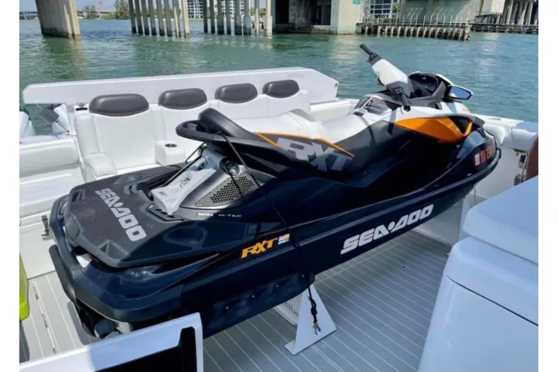  Yacht Photos Pics Jet ski on 2021 HCB 65 Estrella yacht deck, docked near waterfront.