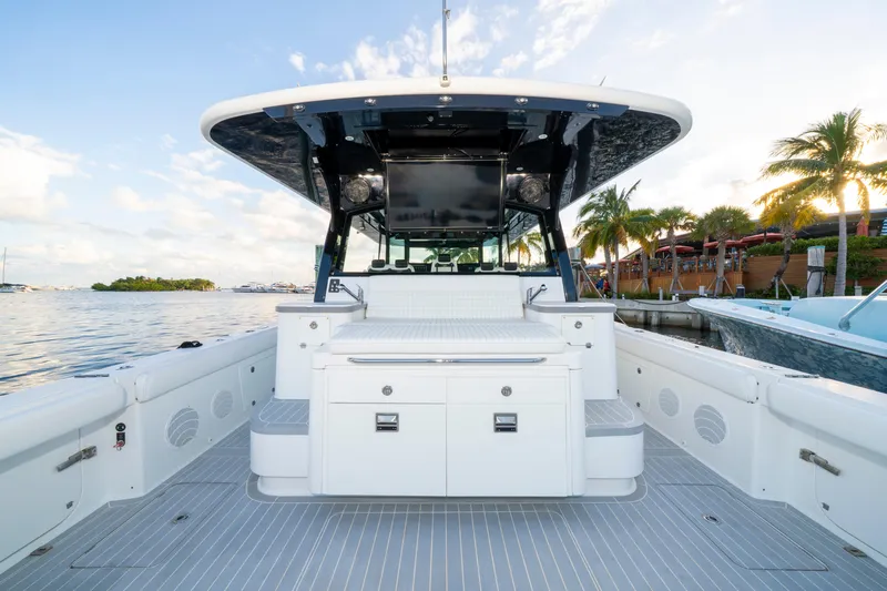  Yacht Photos Pics 2021 HCB 65 Estrella boat interior with sleek design, docked by palm trees.