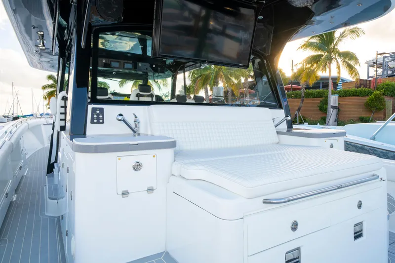  Yacht Photos Pics 2021 HCB 65 Estrella luxury yacht interior with seating and palm trees in background.