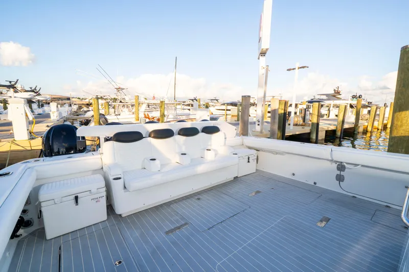  Yacht Photos Pics 2021 HCB 65 Estrella boat interior with white seating at a marina.