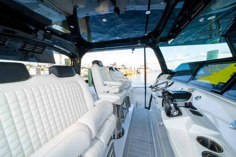  Yacht Photos Pics Luxurious interior of 2021 HCB 65 Estrella boat with plush seating and advanced navigation displays.