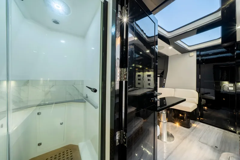  Yacht Photos Pics Luxurious interior of 2021 HCB 65 Estrella yacht with modern shower and seating area.