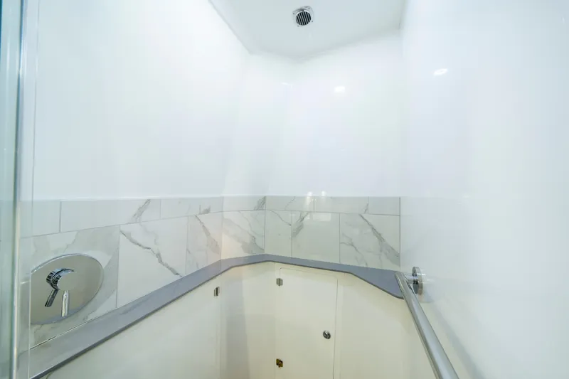  Yacht Photos Pics Luxurious bathroom interior on 2021 HCB 65 Estrella yacht, featuring marble tiles and modern fixtures.