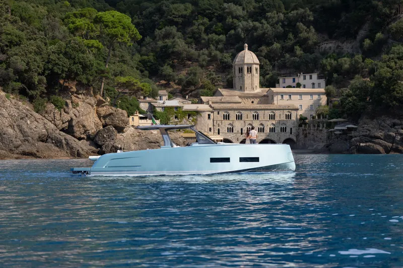 Pardo 43 Yacht Photos Pics 2026 Pardo Yachts 43 cruising near historic coastal architecture and lush greenery.